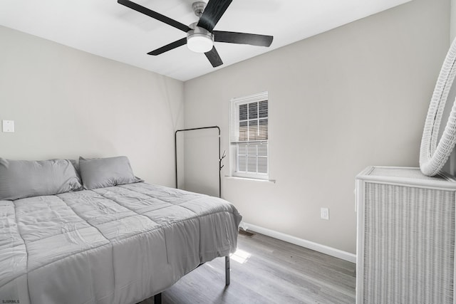 bedroom with ceiling fan and light hardwood / wood-style flooring