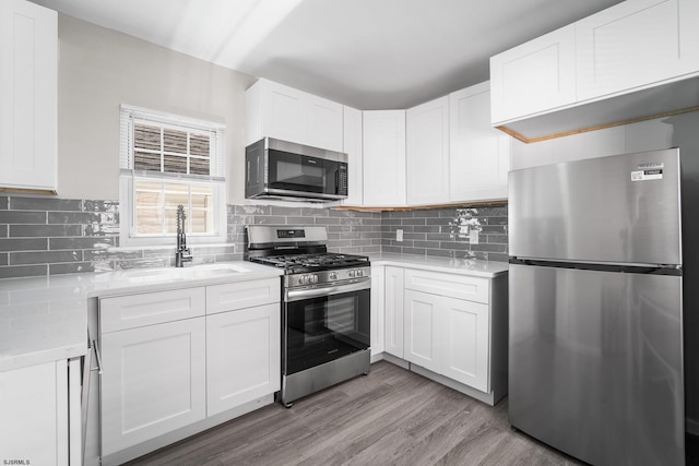 kitchen with white cabinetry and appliances with stainless steel finishes