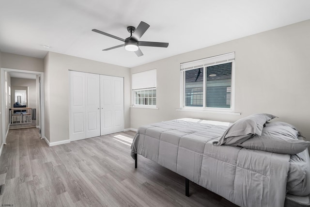 bedroom featuring a closet, ceiling fan, and light wood-type flooring