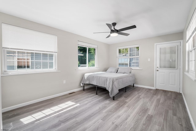 bedroom with ceiling fan and light wood-type flooring