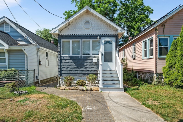 bungalow-style home featuring a front lawn