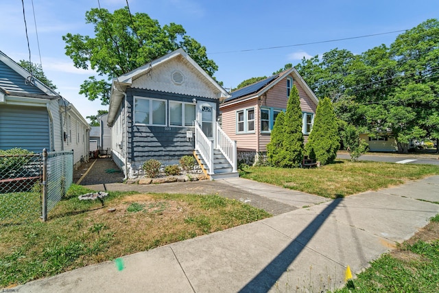 bungalow-style house featuring a front yard