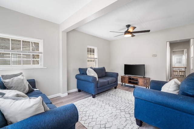 living room with ceiling fan and light hardwood / wood-style flooring