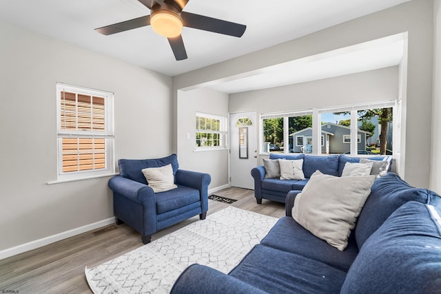 living room featuring light hardwood / wood-style floors and ceiling fan