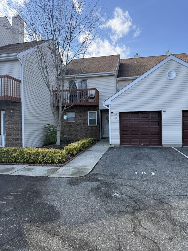 view of front of property with a garage and a balcony