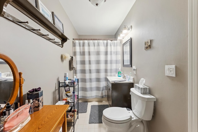 bathroom featuring vanity, toilet, and a shower with shower curtain