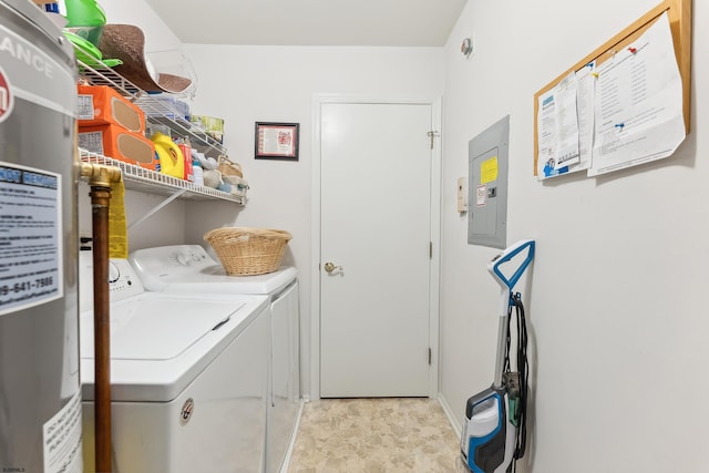 washroom featuring water heater, electric panel, and independent washer and dryer