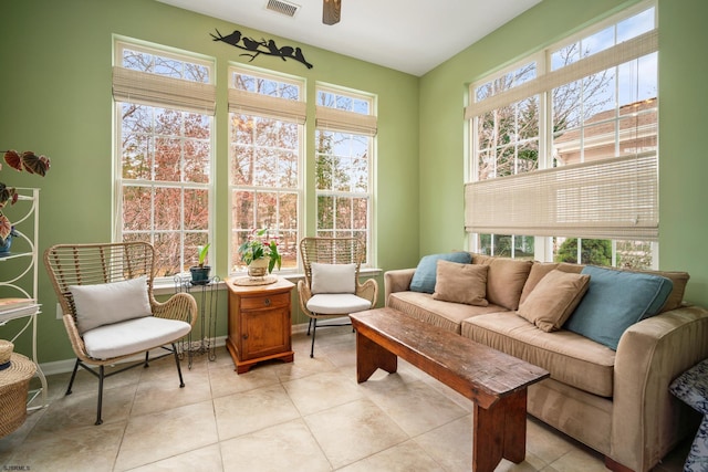 sunroom featuring ceiling fan