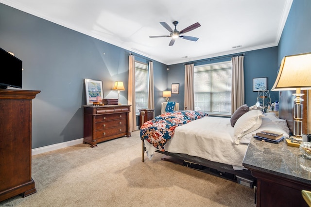 bedroom featuring ceiling fan, ornamental molding, and light colored carpet