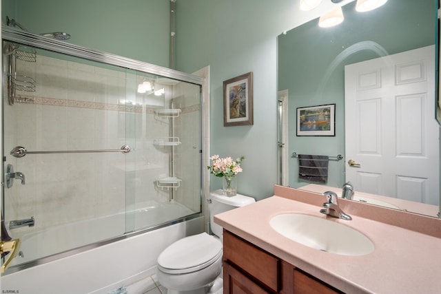 full bathroom featuring bath / shower combo with glass door, vanity, and toilet