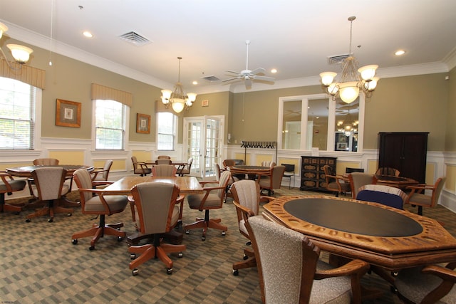 dining space featuring ornamental molding, carpet floors, a notable chandelier, and french doors