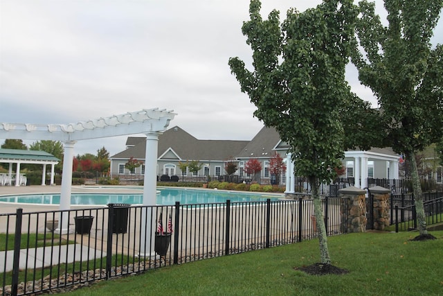 view of swimming pool featuring a yard and a pergola