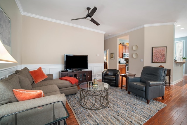 living room with crown molding, ceiling fan, and dark hardwood / wood-style flooring