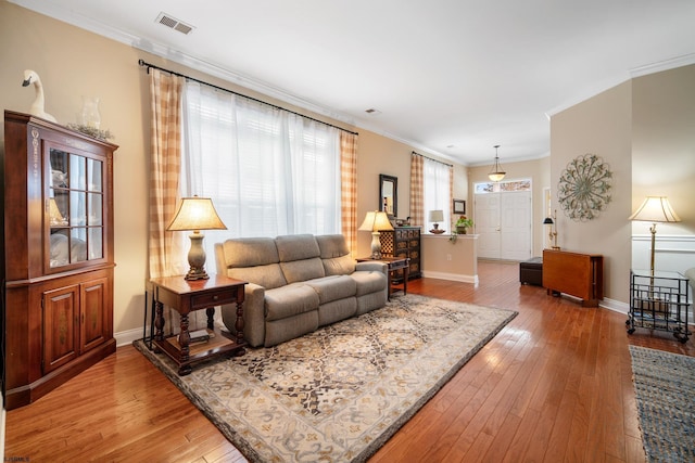 living room with ornamental molding and hardwood / wood-style floors