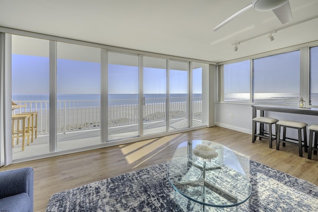 sunroom featuring a water view and a wealth of natural light