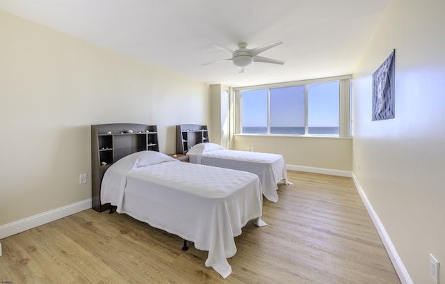 bedroom with ceiling fan and light hardwood / wood-style floors