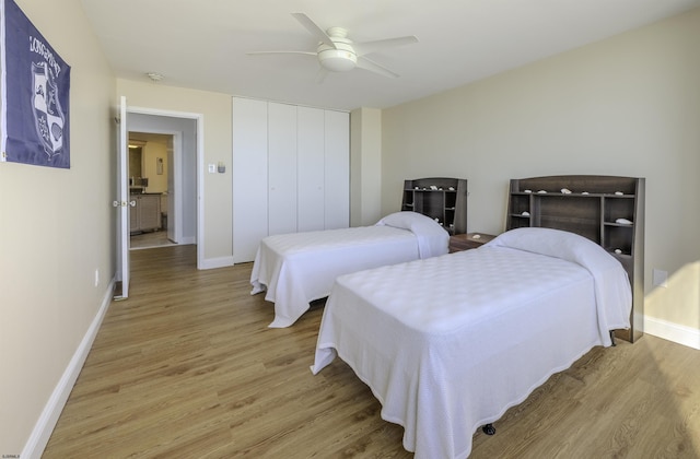 bedroom featuring light hardwood / wood-style floors, a closet, and ceiling fan