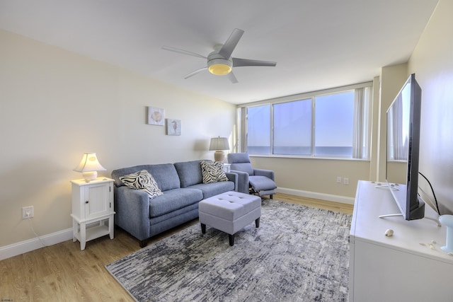 living room featuring ceiling fan and light hardwood / wood-style flooring