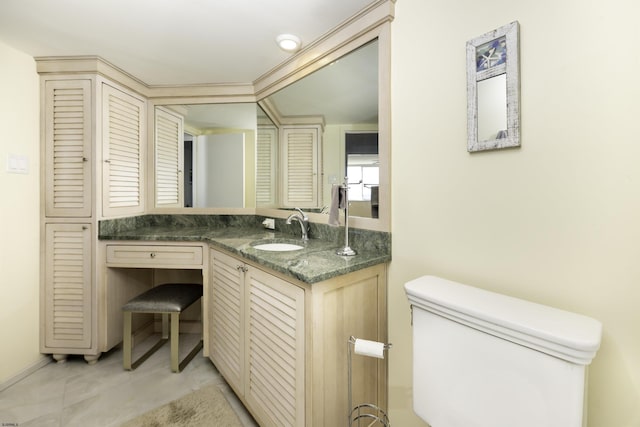 bathroom with vanity, toilet, and tile patterned flooring