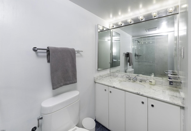 bathroom featuring toilet, vanity, and walk in shower