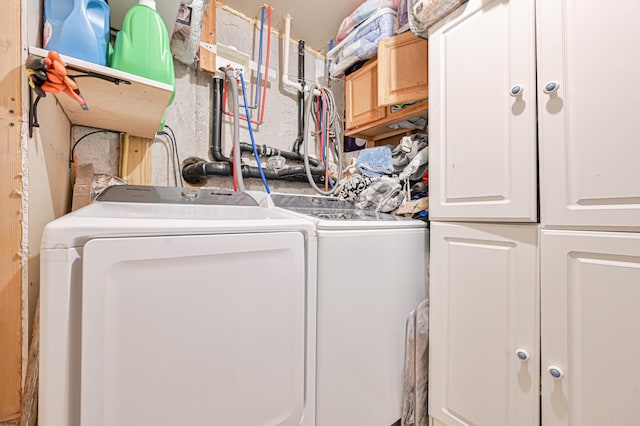 laundry area featuring cabinets and washer and clothes dryer