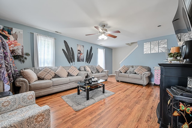 living room featuring light hardwood / wood-style flooring and ceiling fan