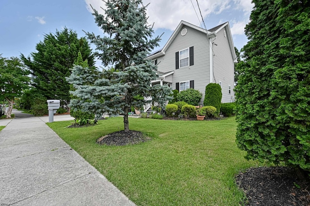 view of side of home with a lawn