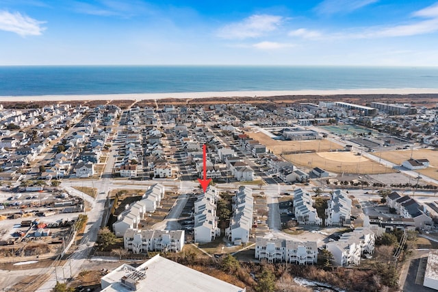 aerial view with a water view and a beach view