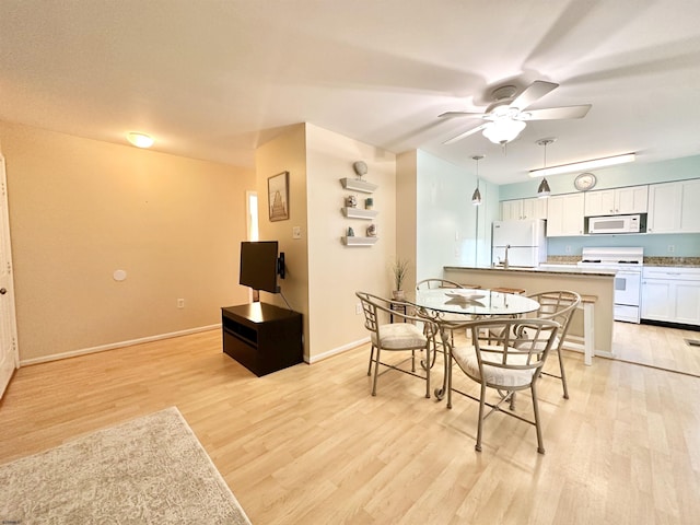 dining area featuring light hardwood / wood-style floors and ceiling fan