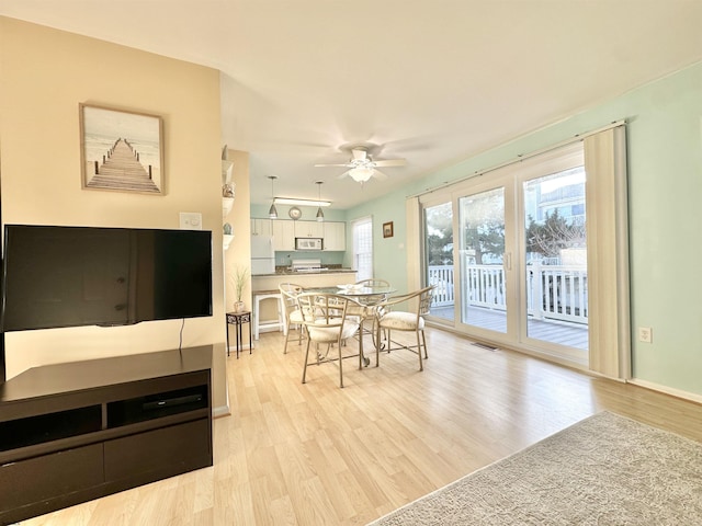 dining area featuring ceiling fan and light hardwood / wood-style floors