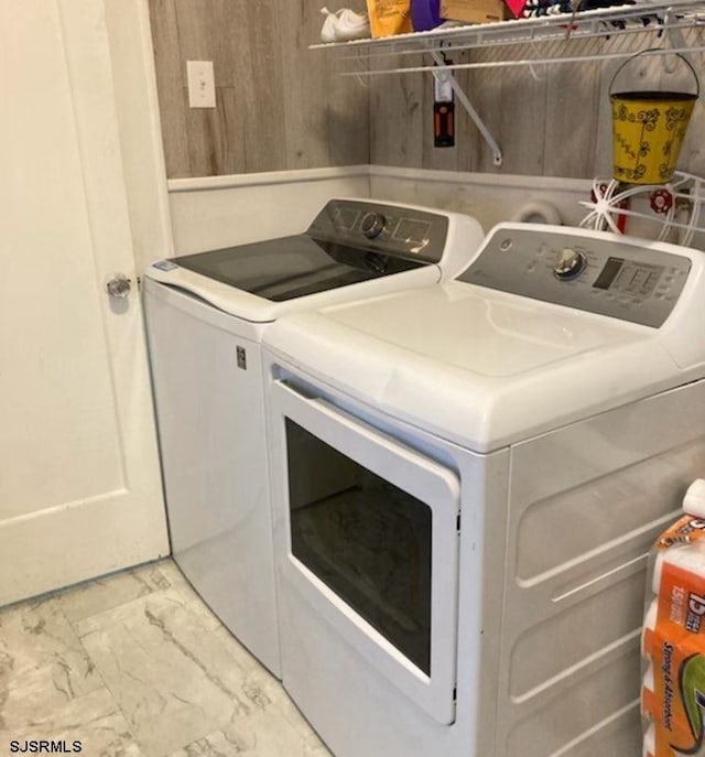 laundry room with marble finish floor, laundry area, and washing machine and dryer