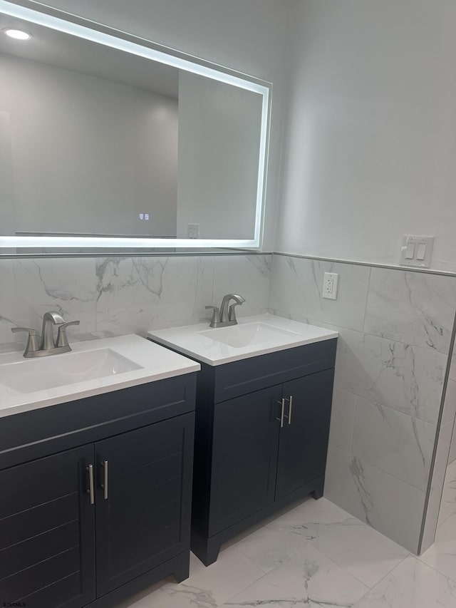 bathroom with vanity and tile walls