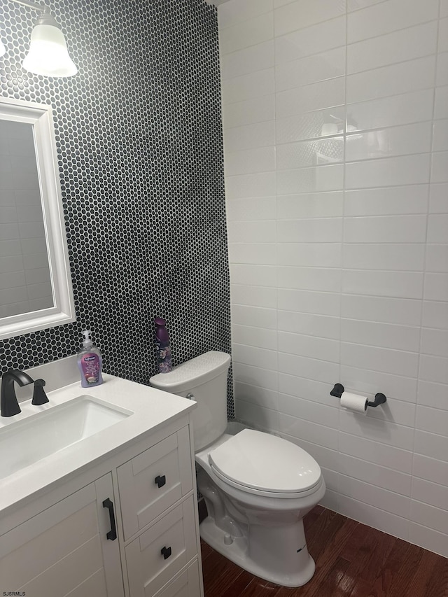 bathroom with vanity, wood-type flooring, and toilet