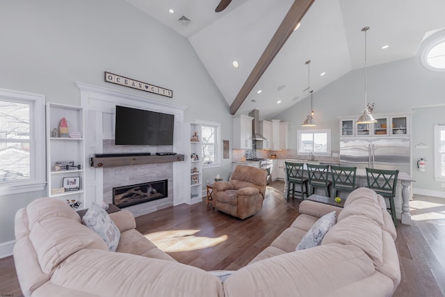 living room featuring dark wood-type flooring, sink, and high vaulted ceiling