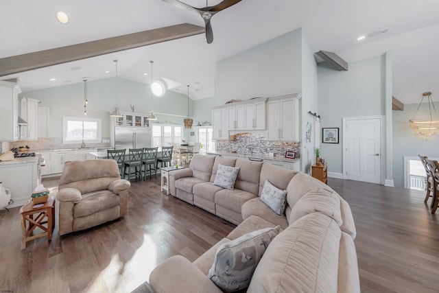 living room with sink, wood-type flooring, high vaulted ceiling, and beamed ceiling