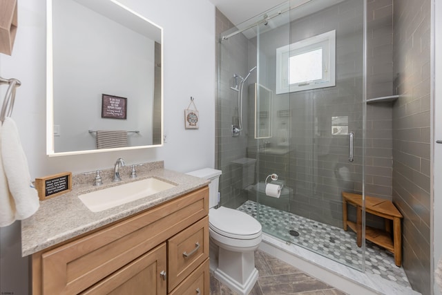 bathroom with vanity, toilet, and walk in shower