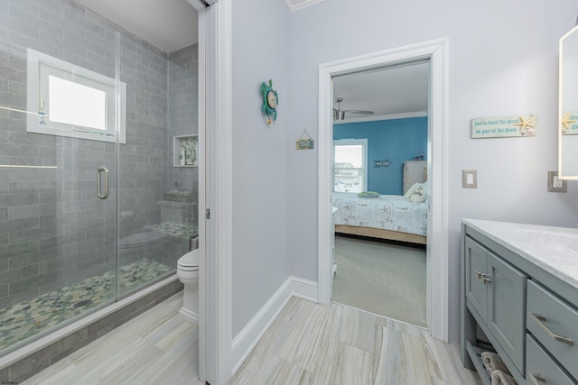 bathroom featuring a shower with door, vanity, a wealth of natural light, and crown molding