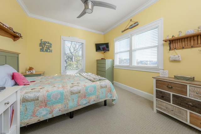 carpeted bedroom featuring ornamental molding and ceiling fan