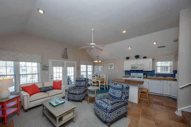 living room featuring light tile patterned floors, vaulted ceiling, and ceiling fan