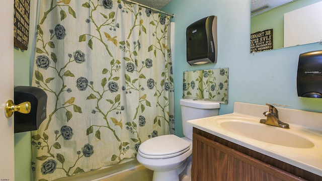 bathroom with walk in shower, vanity, and toilet