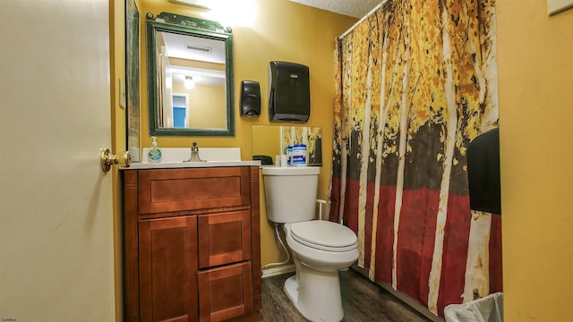 bathroom with vanity, toilet, and hardwood / wood-style floors