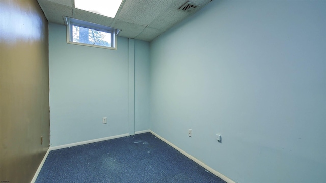 empty room featuring a paneled ceiling