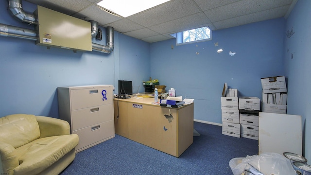 carpeted office space with a drop ceiling