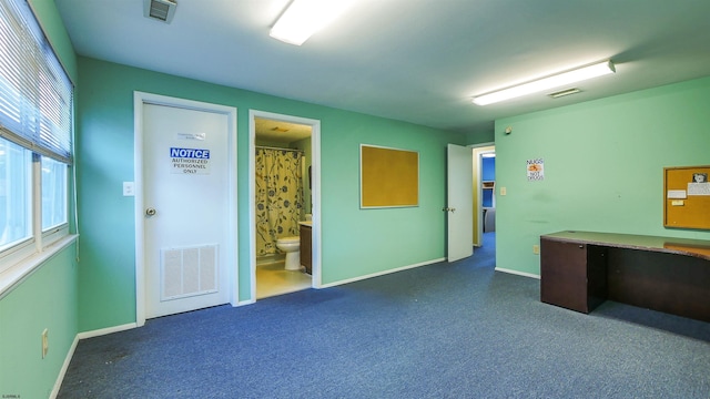 unfurnished office with dark colored carpet