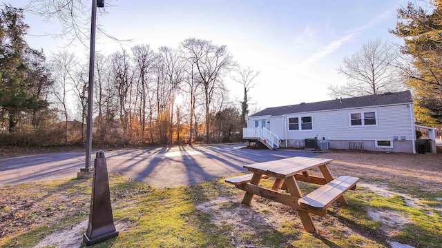 rear view of property with central AC