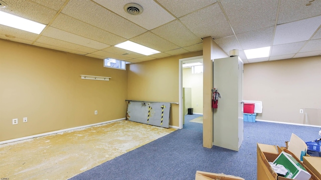 basement with a paneled ceiling