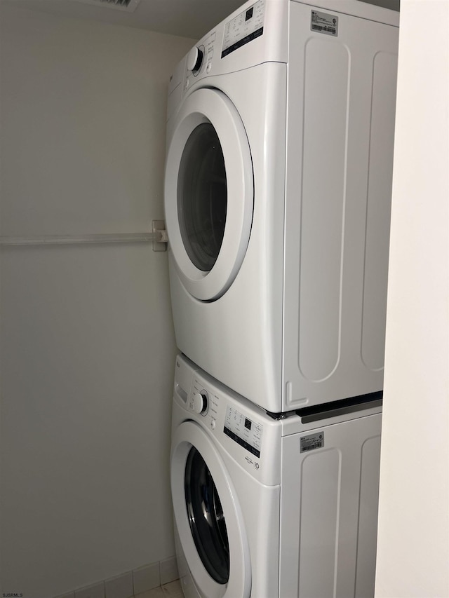 laundry room featuring stacked washer / dryer