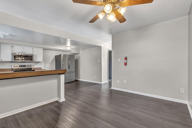 kitchen featuring white cabinetry, stainless steel appliances, dark hardwood / wood-style floors, and ceiling fan