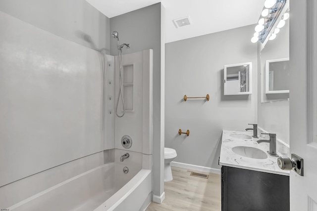 full bathroom with vanity, hardwood / wood-style floors,  shower combination, and toilet