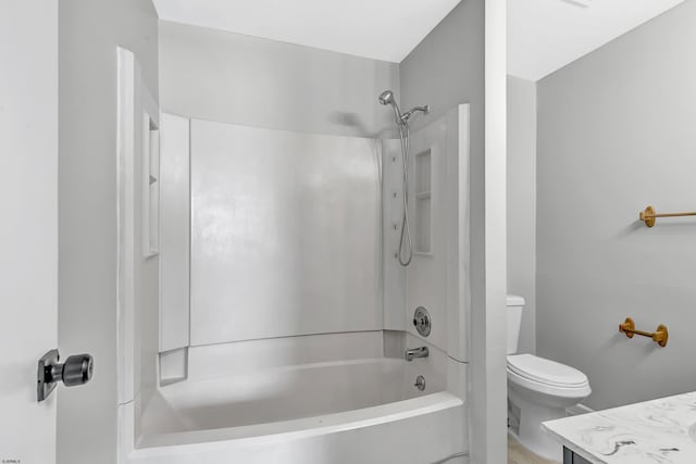 full bathroom featuring washtub / shower combination, vanity, and toilet